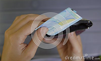 A person pick up a twenty euro. Money in the wallet Stock Photo
