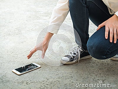 Person Picking Broken Smart Phone of Ground Stock Photo