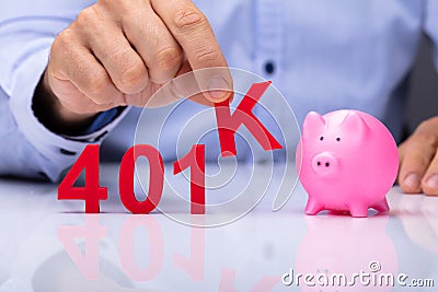Person Picking K Alphabet From 401k Pension Plan Stock Photo