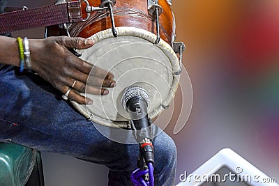 A person playing Dhole, - Dhole/Dholoke is a musical instrument that is sounded by being struck or scraped by a beater Stock Photo