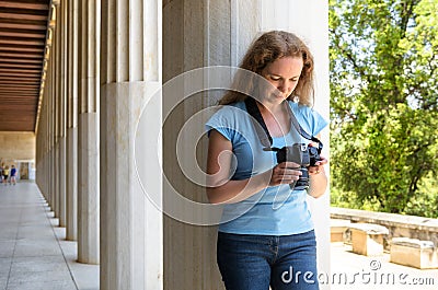Person plays photos in camera at Ancient Greek columns, Athens, Greece Stock Photo
