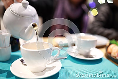 Person pouring herbal tea Stock Photo