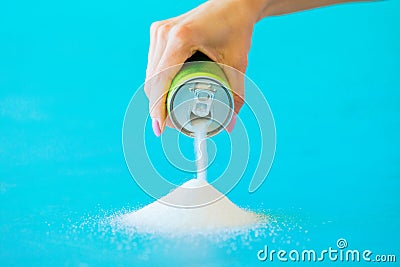 Person pouring sugar out of soft drink can Stock Photo