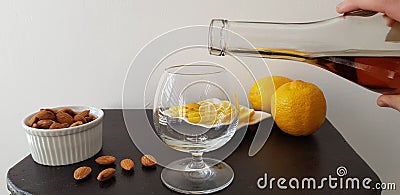 Person pours brandy into a glass Stock Photo