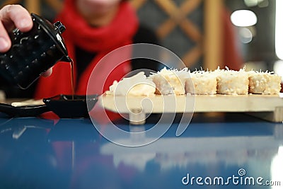 Person pours soy sauce Stock Photo