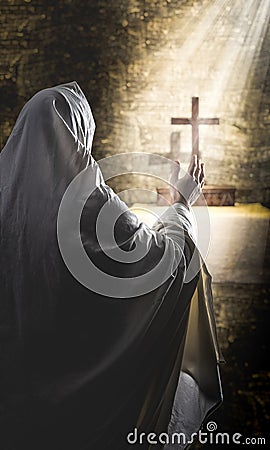 person praying in a cassock Stock Photo