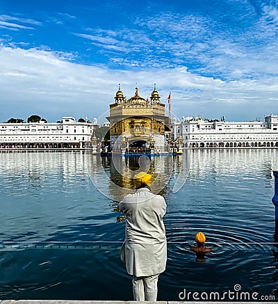 A person prays at Golden Temple amristar with folding hands Stock Photo