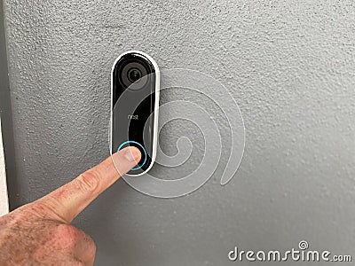 A person pressing a Ring doorbell Editorial Stock Photo