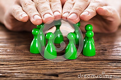 Person Protecting Green Persons Stock Photo