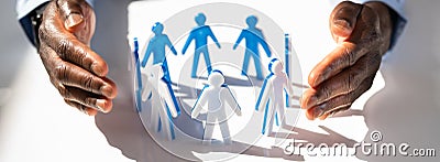 Person Protecting Paper Cut Out Figure Stock Photo