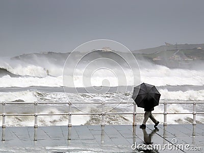 Person protecting with umbrella in a rainy and windy day Stock Photo