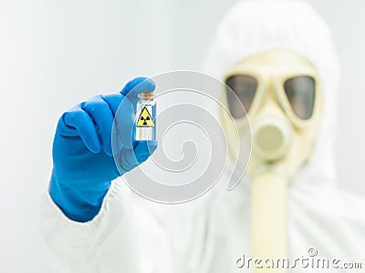 Person in protective suit holding isotope sample Stock Photo