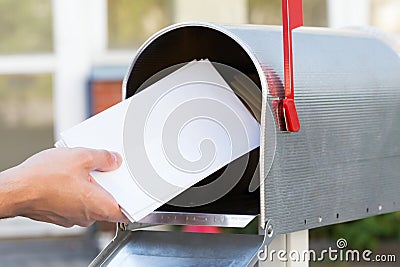 Person Putting Letters In Mailbox Stock Photo