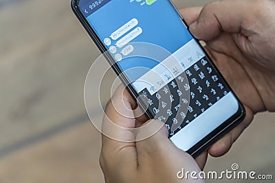 Writing alien messages with hieroglyphs on a smartphone Stock Photo