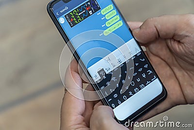 Writing alien messages with hieroglyphs on a smartphone Stock Photo