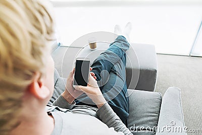 Person relaxing and using smart phone Stock Photo