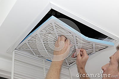 Man Removing Dirty Air Filter Stock Photo