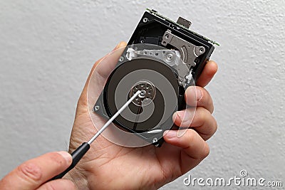 Person repairing the computer's hard drive Stock Photo