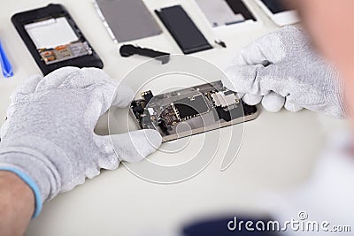 Person Repairing Mobile Phone Stock Photo