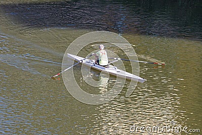 A person rowing boat on Arno River, Florence, Italy Editorial Stock Photo