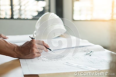 Person`s engineer Hand Drawing Plan On Blue Print with architect Stock Photo