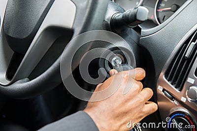 Person`s Hand Inserting Key To Start Car Stock Photo