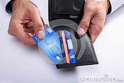 Person Removing Credit Card From Wallet Stock Photo