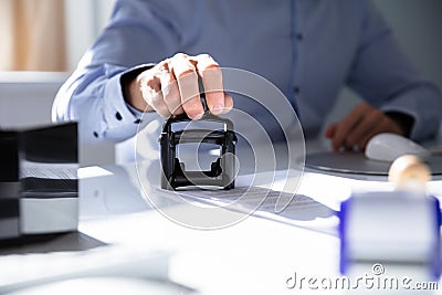 Person`s Hand Stamping With Approved Stamp Stock Photo