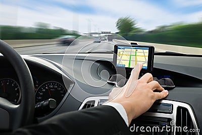 Person's hand using gps navigation system in car Stock Photo