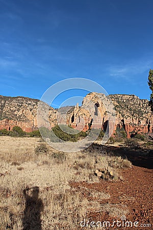 A person's shadow cast on a prairie like plateau on the Brins Mesa Trail in Sedona, Arizona Stock Photo