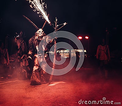 Person in a scary fantasy creature costume at a Halloween parade Stock Photo