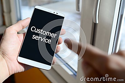 A person sees a white inscription on a black smartphone display Stock Photo