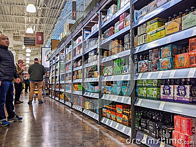 Person shopping for beer and liquor inside a Total Wine and More beverage shop in downtown Bellevue Editorial Stock Photo