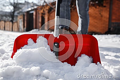 Person shoveling snow outdoors on winter day, closeup Stock Photo