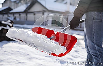 Person shoveling snow outdoors on winter day, closeup Stock Photo