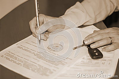 Person signing a document on the sale of the machine Stock Photo