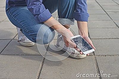 Person holding Broken Smart Phone with a cracked screen Stock Photo