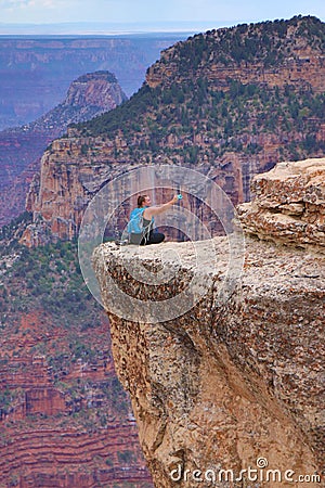 Person taking dangerous selfie in Grand Canyon, Arizona, USA Editorial Stock Photo