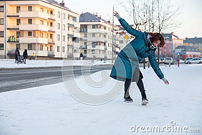 A person slipped on the snow and injured her ankle. Stock Photo