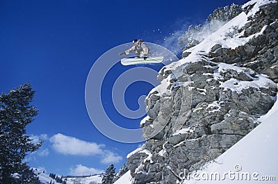 Person On Snowboard Jumping Midair Stock Photo