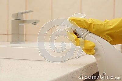 Person spraying detergent onto counter Stock Photo