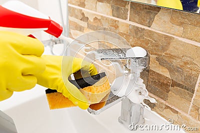 Person spraying water tap with foam Stock Photo