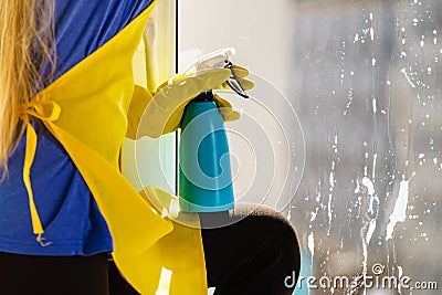 Person spraying window cleaning detergent Stock Photo