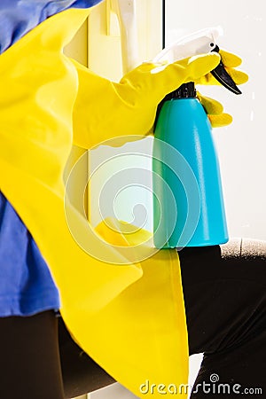 Person spraying window cleaning detergent Stock Photo