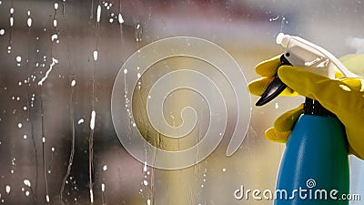 Person spraying window cleaning detergent Stock Photo