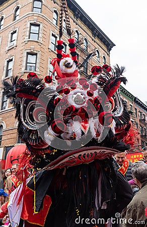 Person in the street wearing an intricate and colorful headpiece during the parade Editorial Stock Photo