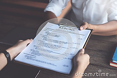 Person submits job application, Interviewer reading a resume Stock Photo