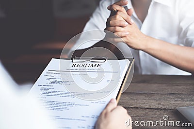Person submits job application, Interviewer reading a resume Stock Photo