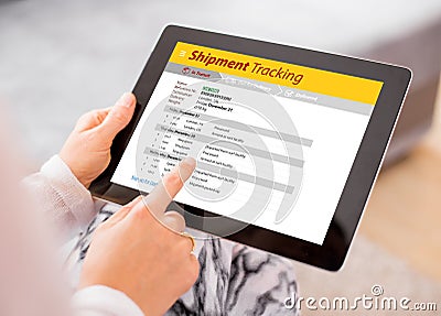 Person tracking shipment on tablet Stock Photo