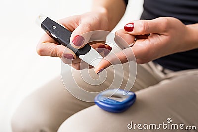 Person using diabetes kit Stock Photo